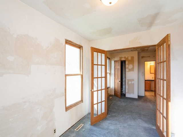 carpeted empty room with french doors