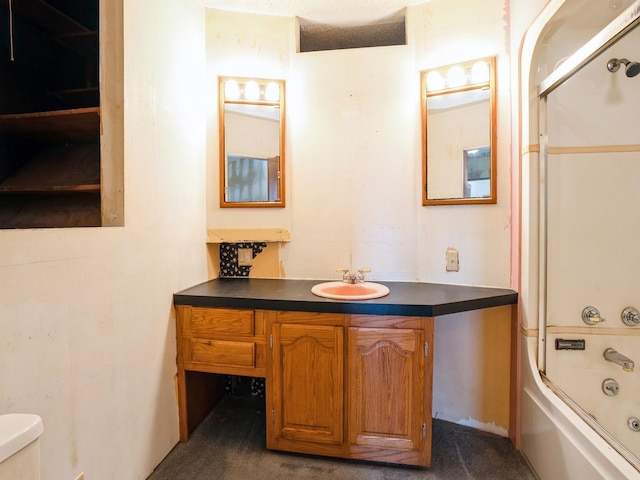 full bathroom featuring vanity, toilet, enclosed tub / shower combo, and a textured ceiling