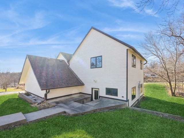 rear view of property with a lawn and a patio area