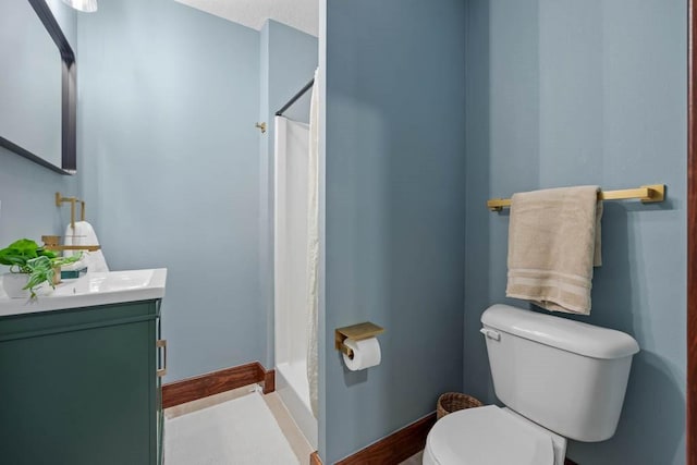 bathroom with walk in shower, vanity, and toilet