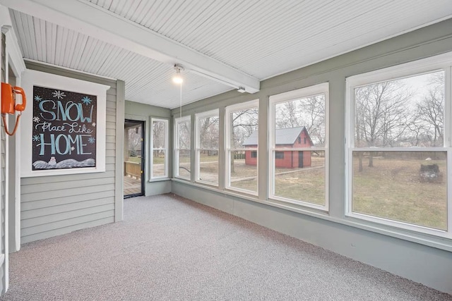 unfurnished sunroom with beam ceiling