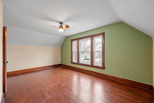 bonus room featuring hardwood / wood-style flooring, lofted ceiling, and a textured ceiling