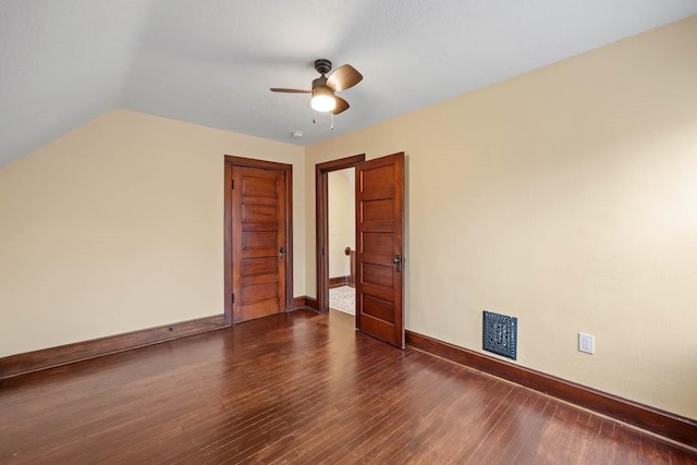 interior space with dark wood-type flooring, ceiling fan, and vaulted ceiling