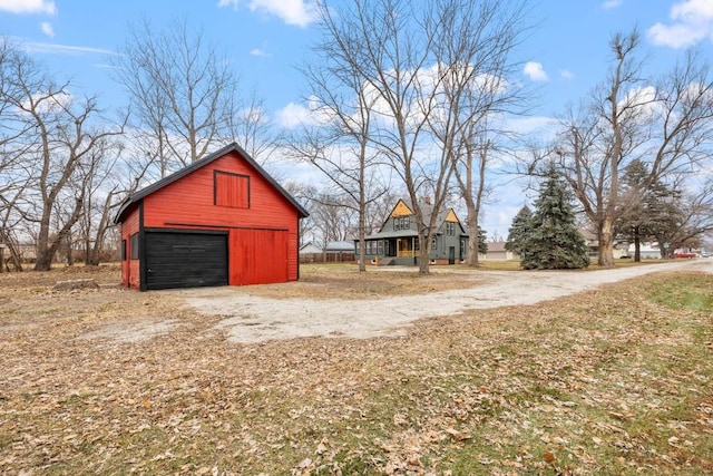 exterior space featuring a garage and an outbuilding