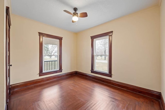 empty room with parquet floors, a healthy amount of sunlight, and crown molding