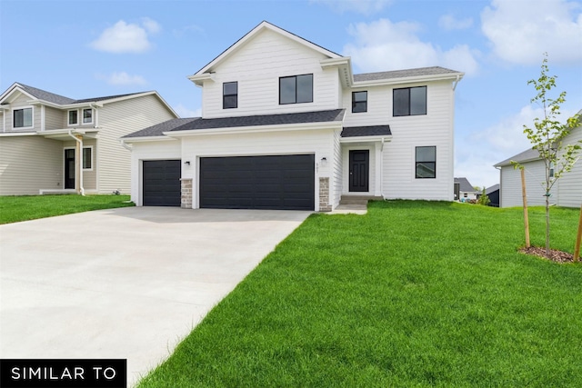 view of front of property with a front yard and a garage