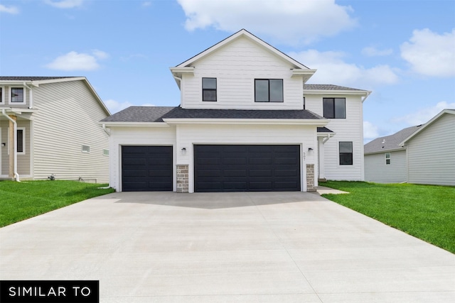 view of front of home featuring a front lawn and a garage