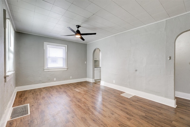 empty room with ceiling fan and hardwood / wood-style flooring