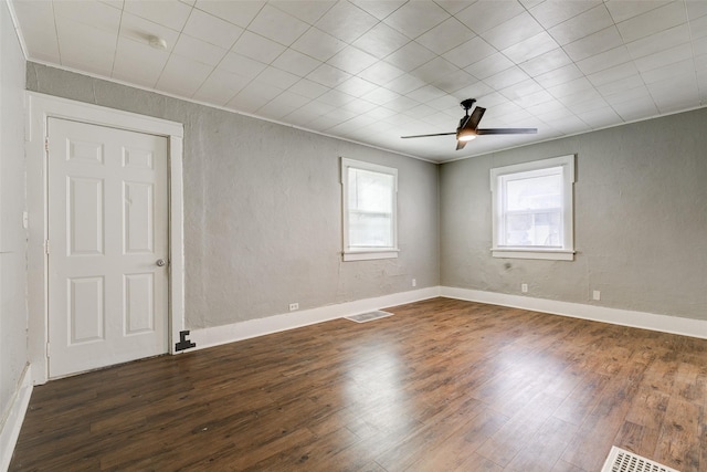 unfurnished room with ceiling fan and dark hardwood / wood-style flooring