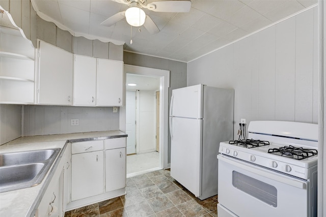 kitchen featuring white appliances, white cabinetry, ceiling fan, and sink