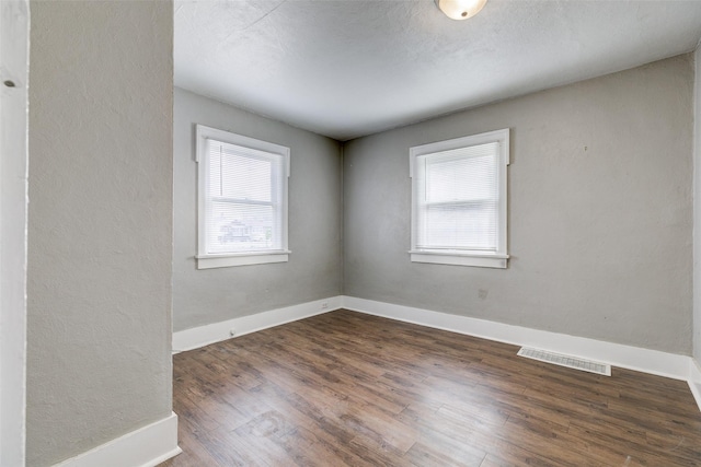 unfurnished room featuring dark hardwood / wood-style floors