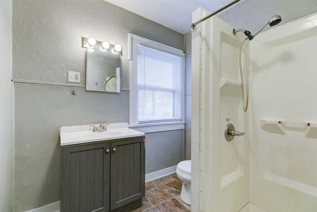 bathroom with vanity, toilet, and walk in shower