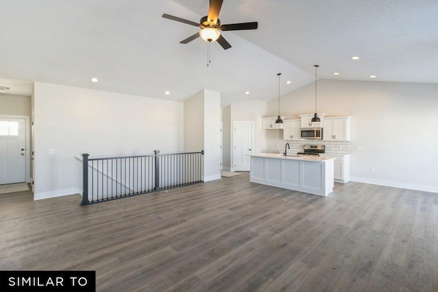 unfurnished living room with ceiling fan, sink, dark wood-type flooring, and lofted ceiling