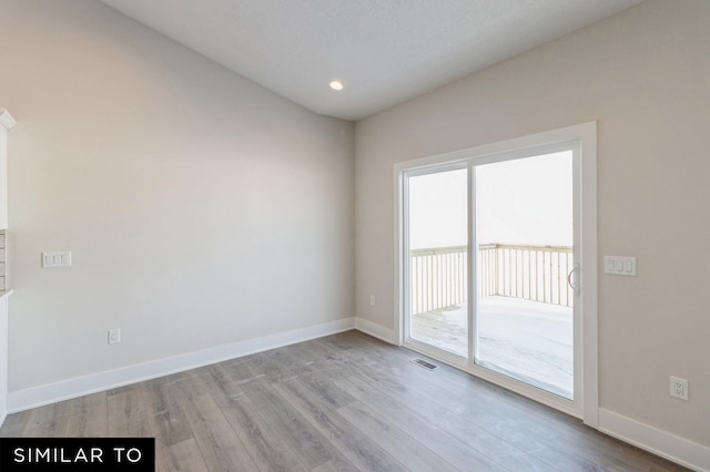 spare room with light hardwood / wood-style flooring