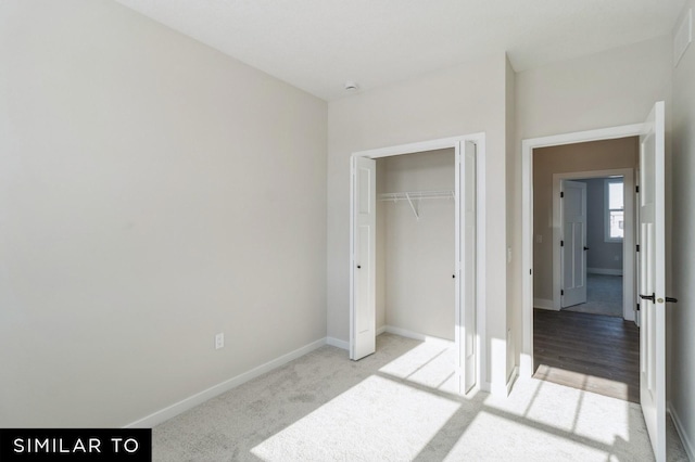 unfurnished bedroom featuring a closet and light hardwood / wood-style floors