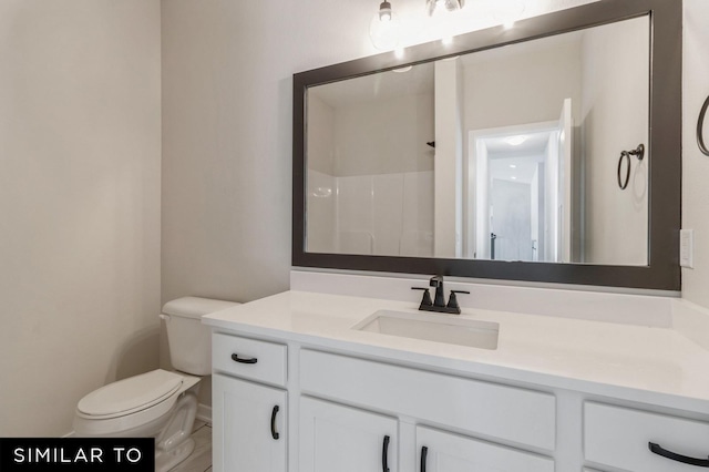 bathroom with vanity, toilet, and walk in shower