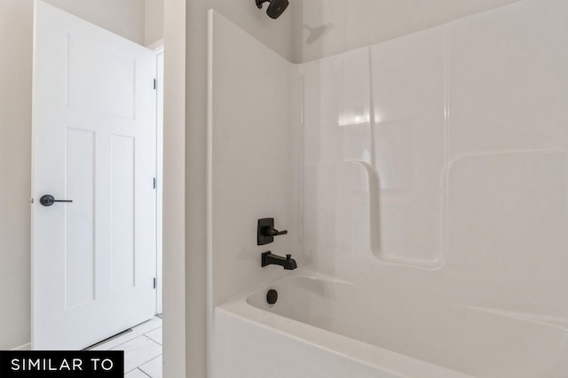 bathroom featuring tile patterned flooring and bathing tub / shower combination