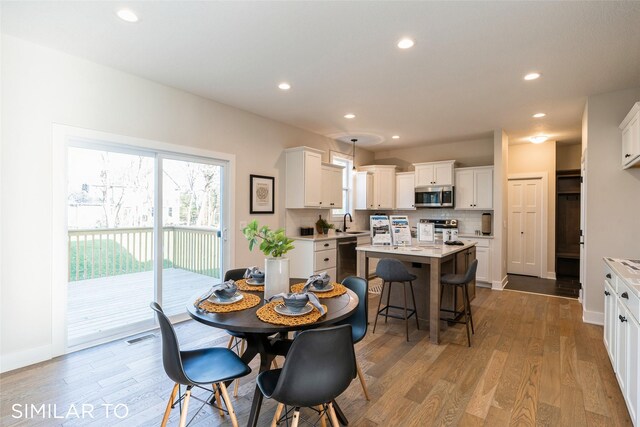 dining room with light wood-type flooring and sink