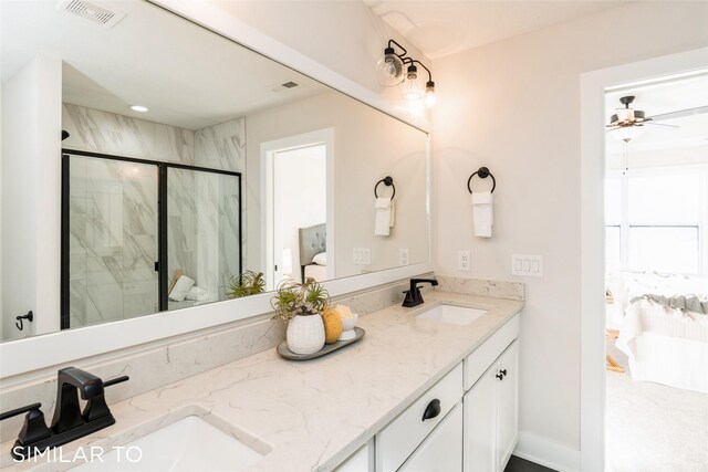 bathroom featuring vanity, ceiling fan, and a shower with shower door