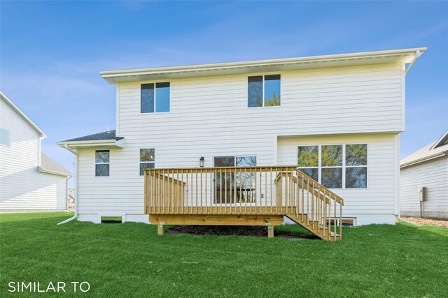 back of house featuring a deck and a lawn