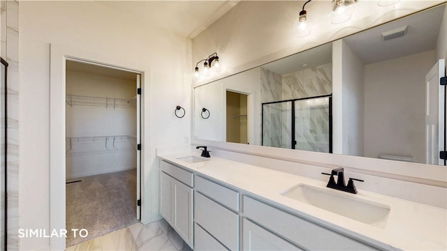 bathroom featuring vanity, toilet, and a shower with door