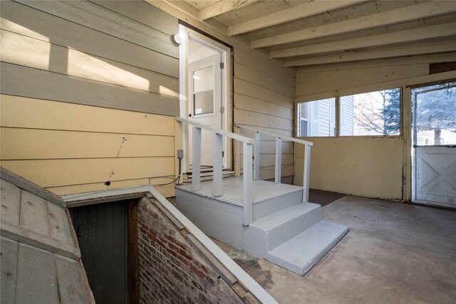 stairway featuring wooden walls and concrete floors