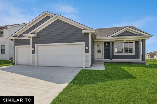 view of front of property featuring a garage and a front yard