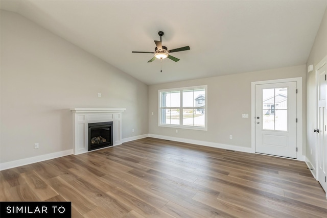 unfurnished living room featuring hardwood / wood-style flooring, ceiling fan, and lofted ceiling