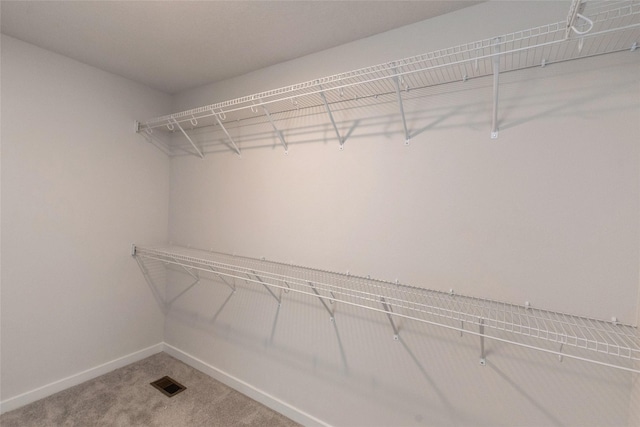 walk in closet featuring carpet flooring and visible vents