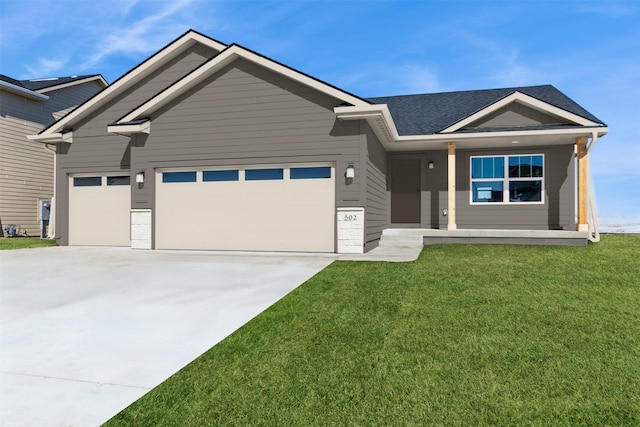 ranch-style home with a garage, driveway, and a front lawn