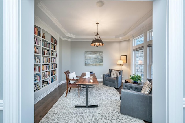 sitting room with wood-type flooring and crown molding