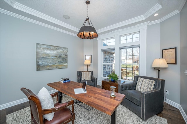 home office with hardwood / wood-style floors, a raised ceiling, ornamental molding, a textured ceiling, and decorative columns