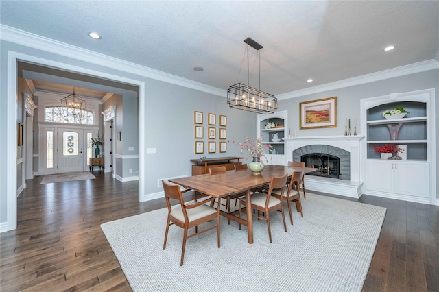 dining area with built in shelves, crown molding, dark hardwood / wood-style flooring, and a textured ceiling