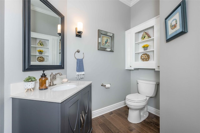 bathroom featuring vanity, hardwood / wood-style flooring, toilet, and crown molding