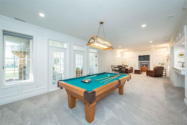 game room with a textured ceiling, light colored carpet, crown molding, and pool table