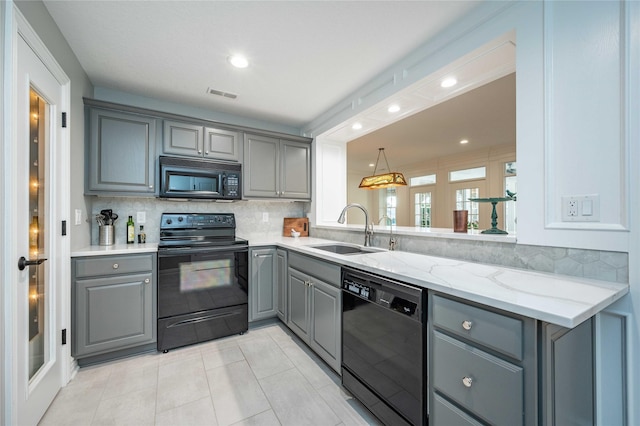 kitchen with backsplash, gray cabinets, sink, and black appliances