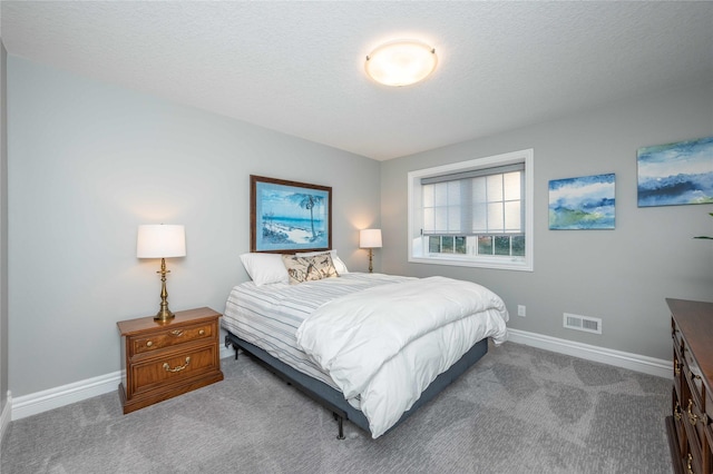 bedroom featuring carpet flooring and a textured ceiling