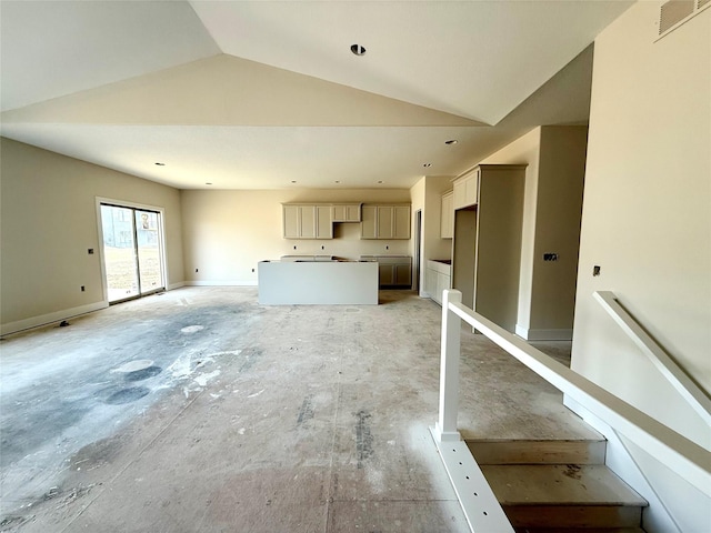 unfurnished living room featuring lofted ceiling