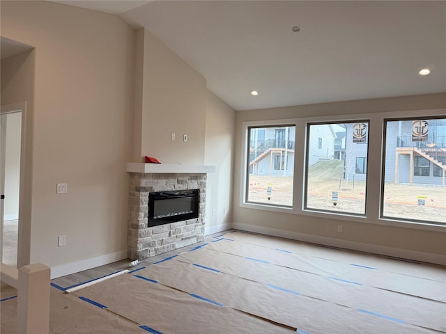 unfurnished living room featuring a fireplace and vaulted ceiling