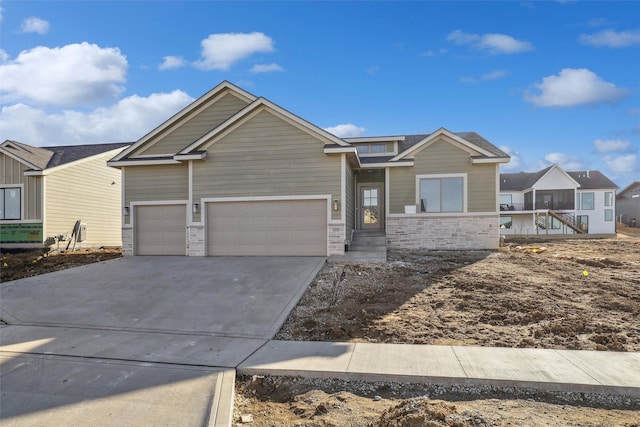 view of front of house with concrete driveway, an attached garage, and stone siding