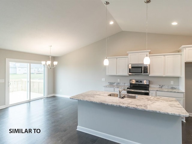 kitchen with white cabinets, stainless steel appliances, lofted ceiling, and sink