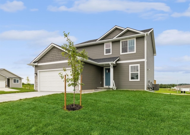 view of front facade with central AC unit, a garage, and a front yard