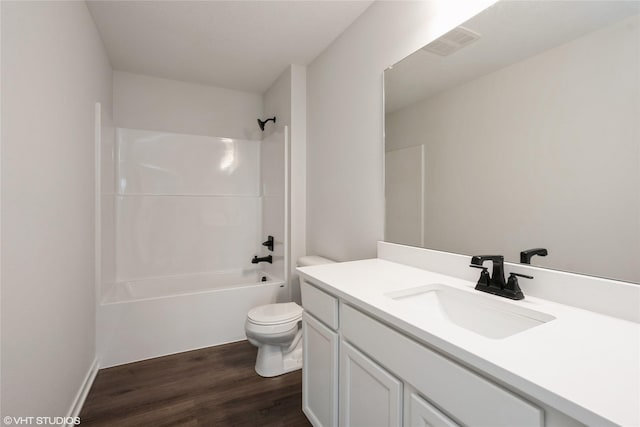 full bath with visible vents, toilet, shower / bath combination, wood finished floors, and vanity