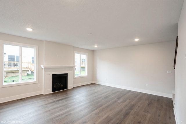 unfurnished living room featuring a fireplace, visible vents, recessed lighting, and dark wood finished floors