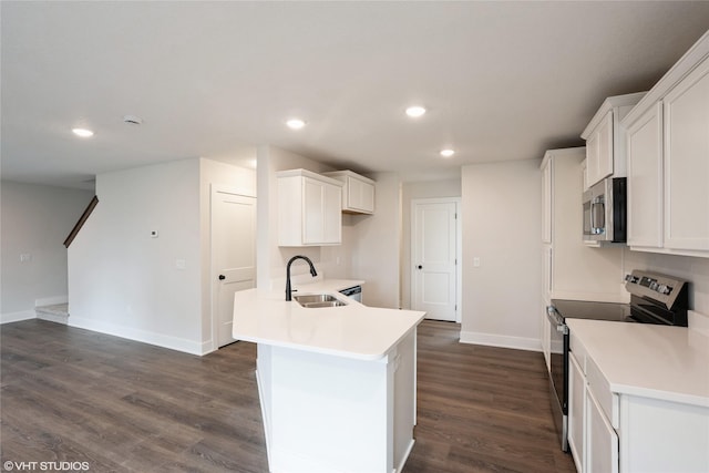 kitchen featuring white cabinetry, a sink, appliances with stainless steel finishes, baseboards, and recessed lighting