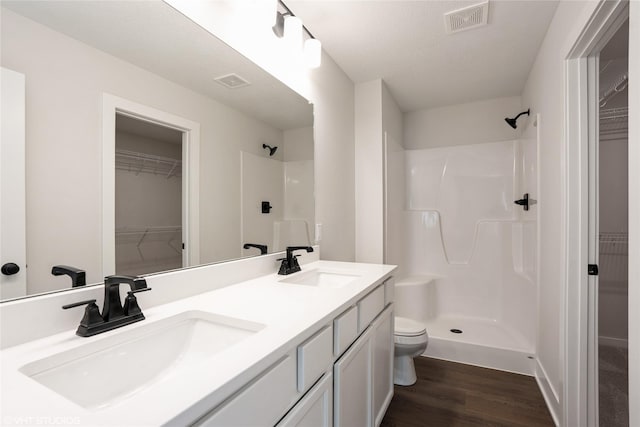 bathroom featuring a sink, a shower, and visible vents