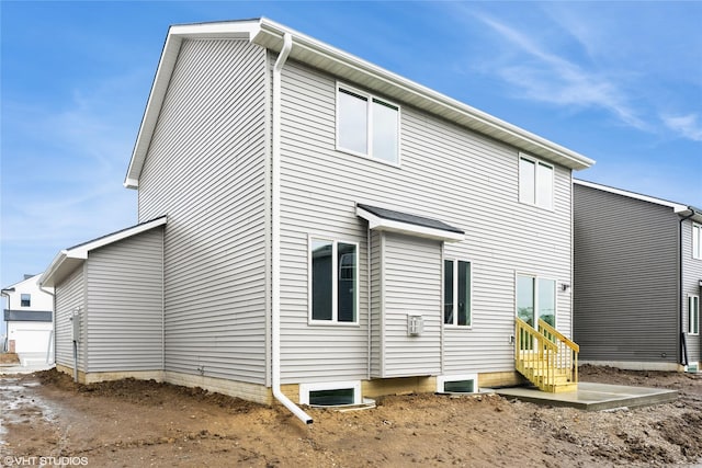 back of property featuring entry steps
