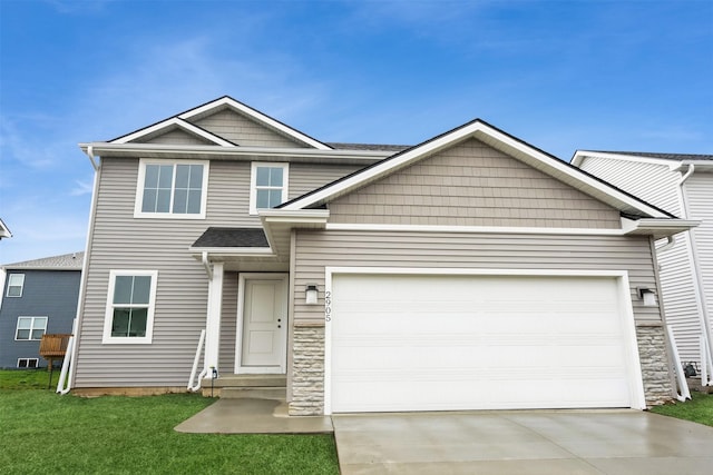 2905 Yordi Dr, Norwalk, IA 50211 - view of front of home with a garage, a front lawn, stone siding, and concrete driveway