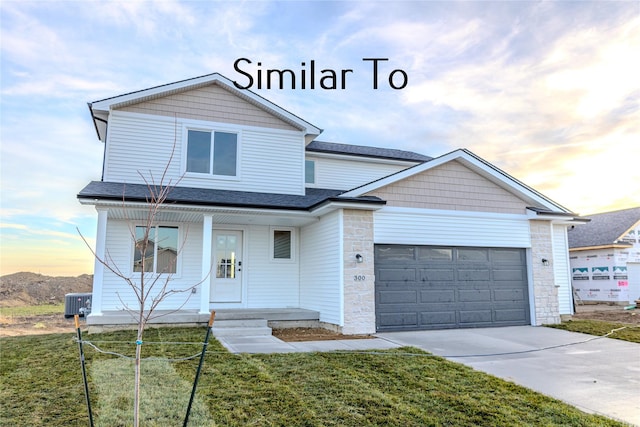 view of front of property with covered porch, a garage, a yard, and central air condition unit