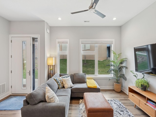 living room featuring recessed lighting, ceiling fan, baseboards, and wood finished floors